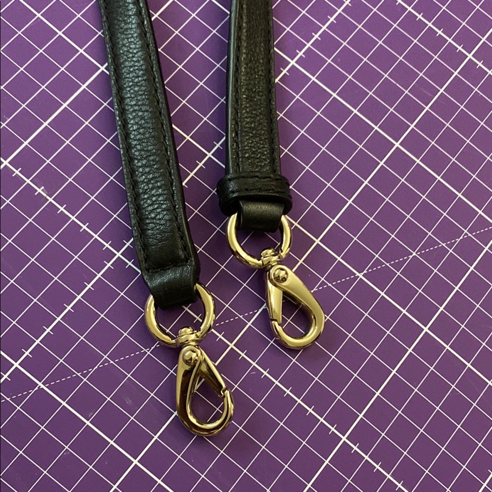 Kate Spade Black Leather Strap with light Gold Clasps.